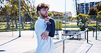 Tennis court, stretching arms and man for fitness, training and practice for game. Outdoor sports, athlete and person with warm up for workout, hobby and exercise for match, tournament and challenge