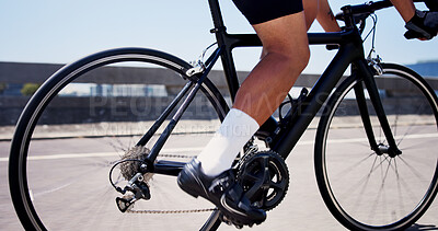 Buy stock photo Legs, cycling and bike on bridge for exercise, cardio workout and outdoor on road with speed in town. Person, bicycle and feet on pedals, triathlon training or challenge for fitness in urban city