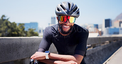 Buy stock photo Black man, cyclist and happy with sunglasses in city, fitness and helmet on bridge, break or pride in street. African person, confident and bike for training, exercise or smile on road in urban town