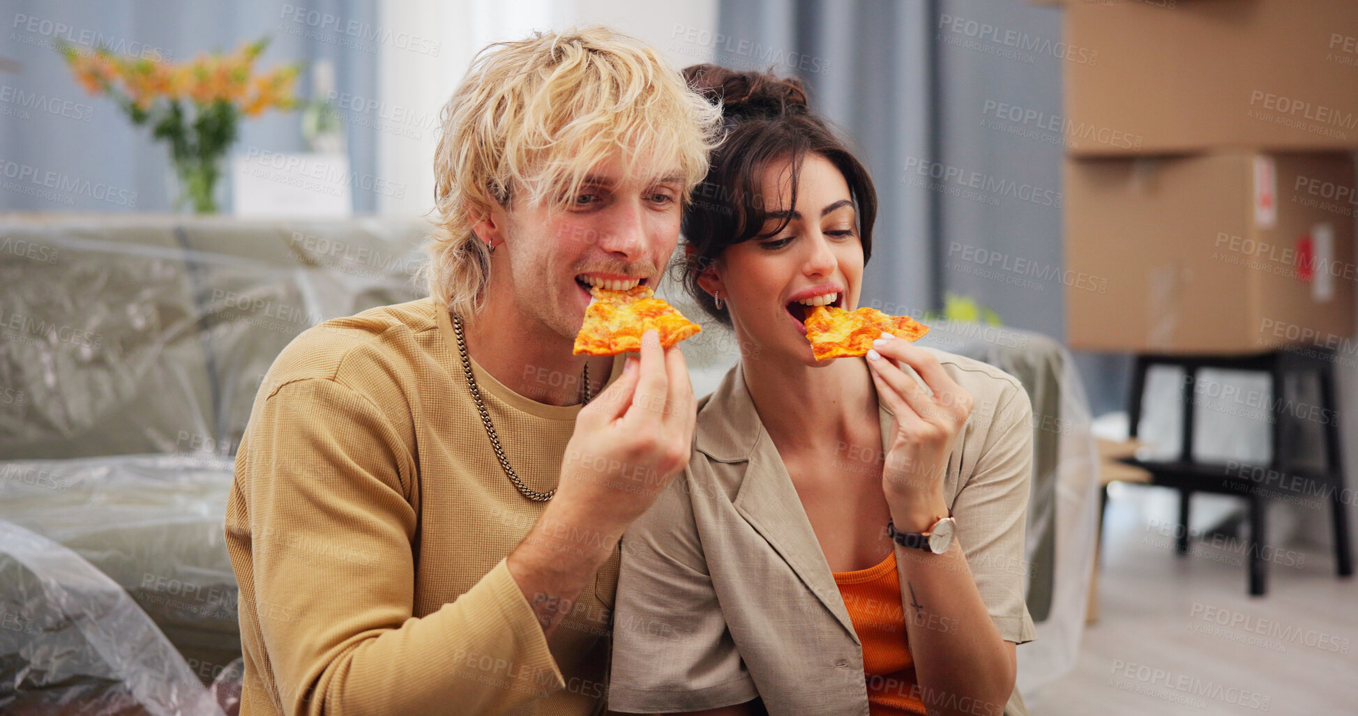 Buy stock photo Love, moving day and pizza with couple in new home together for fresh start or relocation. Boxes, food and property investment with happy people eating takeaway in apartment for bonding or growth