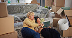 Couple, tablet and new home with boxes on floor, discussion and online shopping for interior design. Woman, man and smile with tech, talk and application with moving, property or real estate at house