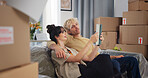 Couple, tablet and moving in with boxes in new home for bonding, interior design and idea app in property. People, technology and relocation in lounge for love, real estate development or renovation