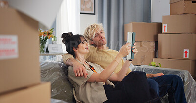 Buy stock photo Couple, tablet and moving in with boxes in new home for bonding, interior design and idea app in property. People, technology and relocation in lounge for love, real estate development or renovation