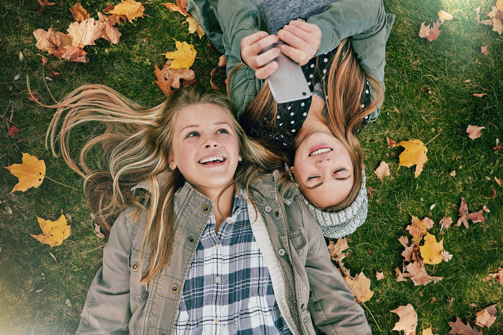 Buy stock photo Phone, reading and chat with friends in park for social media comment, post status update and text message. Communication app, online platform and bonding with above of girl outdoor as teenager