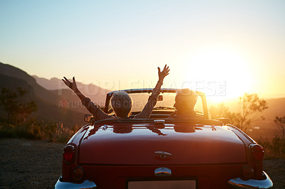 Buy stock photo Freedom, sunset and back of couple in car on road trip, vacation or weekend together with travel. Adventure, space and man with woman driving in convertible vehicle at holiday destination in summer.