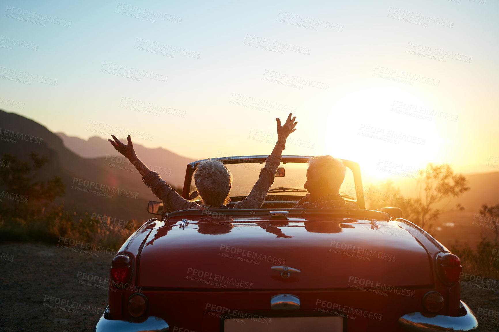 Buy stock photo Freedom, sunset and back of couple in car on road trip, vacation or weekend together with travel. Adventure, space and man with woman driving in convertible vehicle at holiday destination in summer.