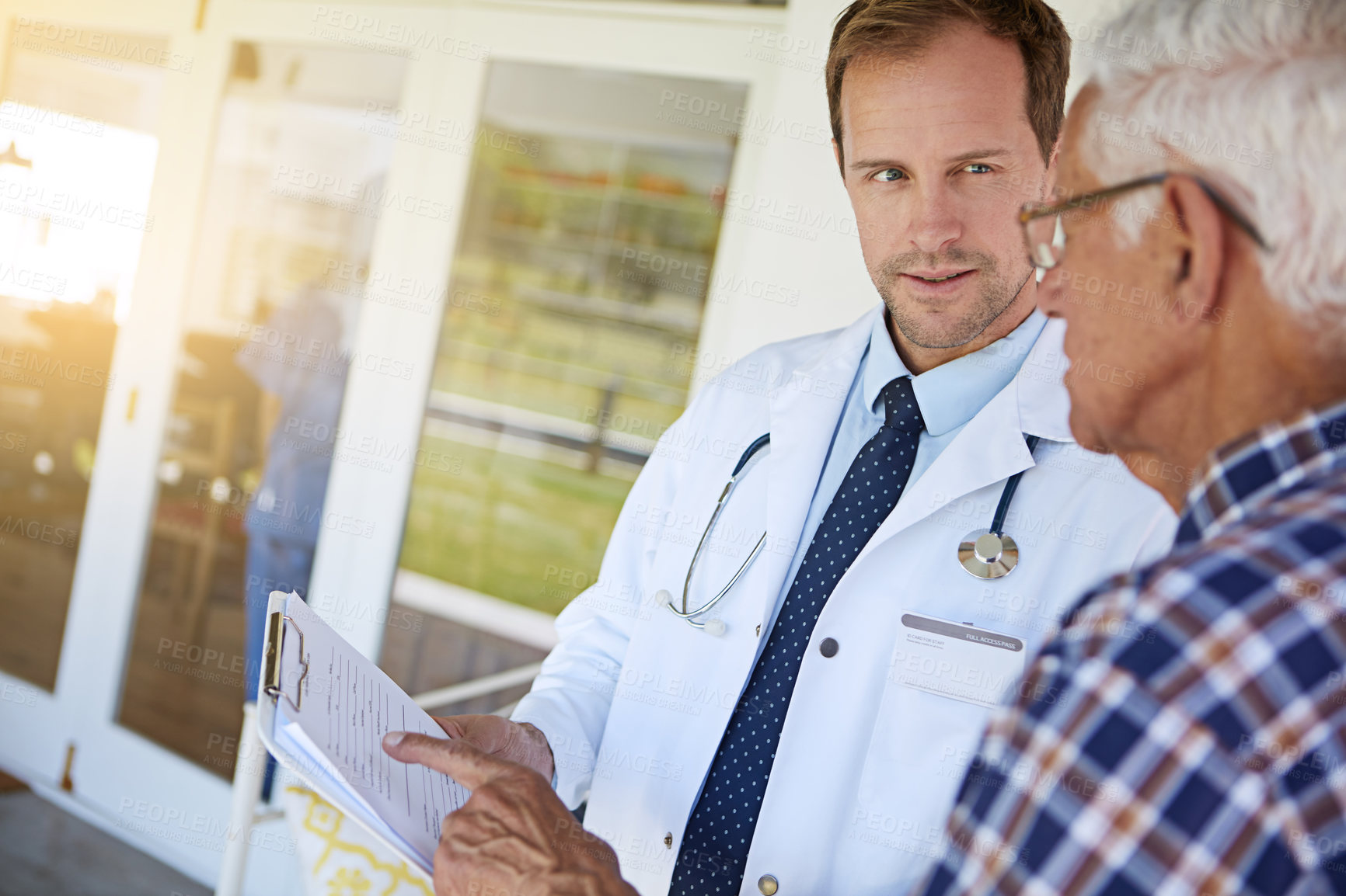 Buy stock photo Clipboard, discussion and doctor with senior man in clinic for consultation on medical diagnosis. Checklist, checkup and healthcare worker with elderly male patient for treatment planning in hospital