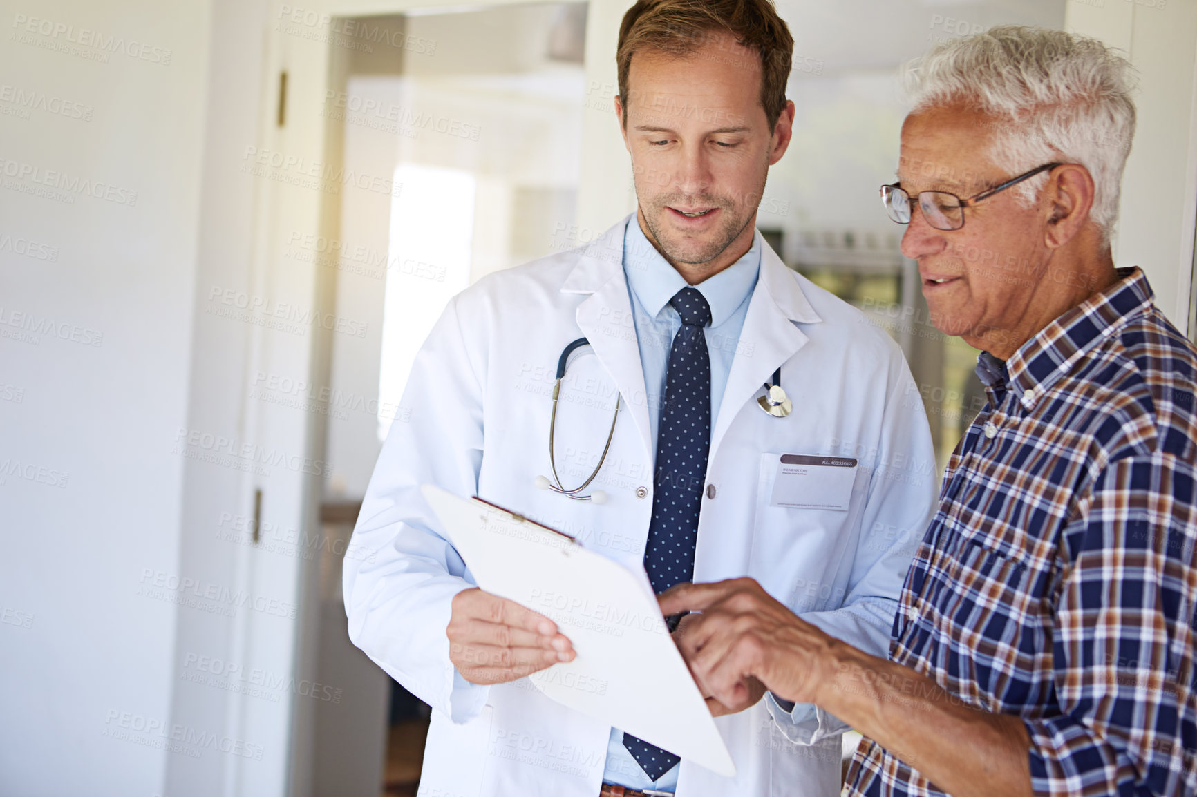 Buy stock photo Clipboard, checkup and doctor with elderly man in clinic for discussion on medical diagnosis. Checklist, consultation and healthcare worker with senior male patient for treatment planning in hospital