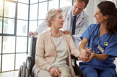 Buy stock photo Doctor, nurse and old woman in wheelchair, holding hands for healing or healthcare consulting. Conversation, medical and recovery of senior patient with disability in hospital for rehabilitation