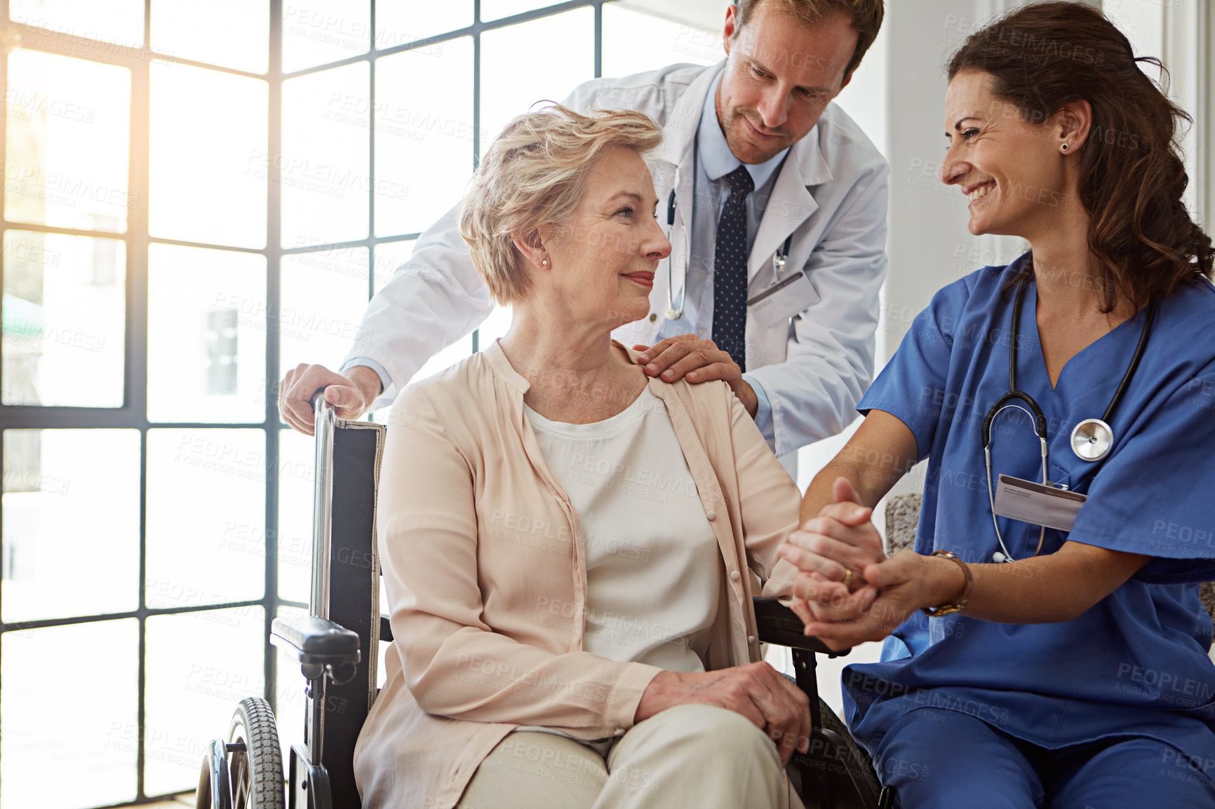 Buy stock photo Doctor, nurse and old person in wheelchair for healthcare, medical consulting or recovery. Conversation, holding hands and rehabilitation of senior woman with disability in hospital for healing