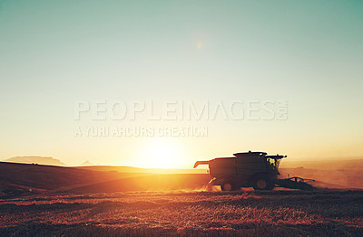 Buy stock photo Nature, sunset and combine harvester of outdoor field for environment, countryside and flare on horizon. Machine, morning and landscape of rural farm with agriculture, ecosystem and agribusiness