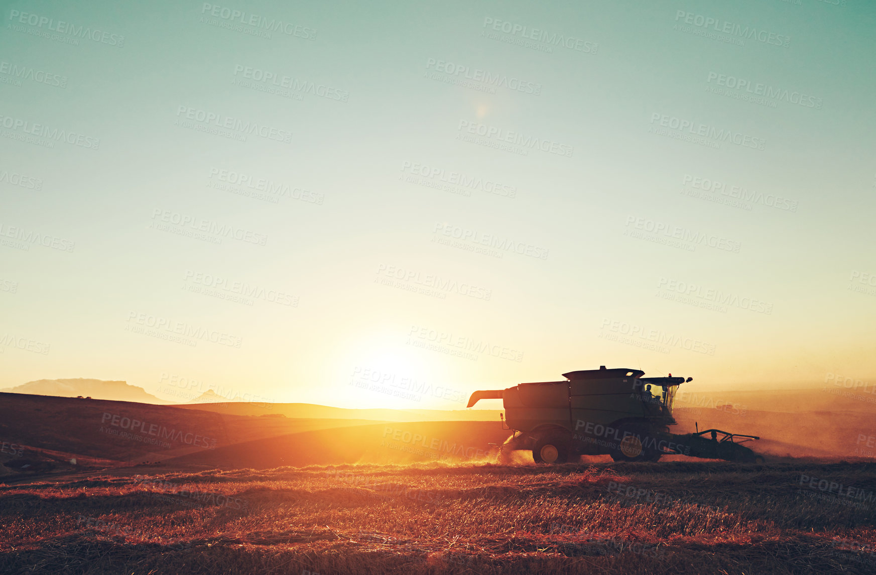 Buy stock photo Nature, sunset and combine harvester of outdoor field for environment, countryside and flare on horizon. Machine, morning and landscape of rural farm with agriculture, ecosystem and agribusiness
