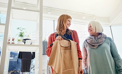 Buy stock photo Shopping, happy and woman with senior mother in mall for discount, fashion sale and bargain. Clothes, low angle and elderly person and daughter in boutique for purchase, retail and bonding on weekend