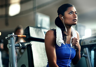 Buy stock photo Tired, fitness and woman in gym, earphones for podcast and exercise for health benefits. Listen, decision and person in wellness facility, training and streaming music with break, sound or reflection