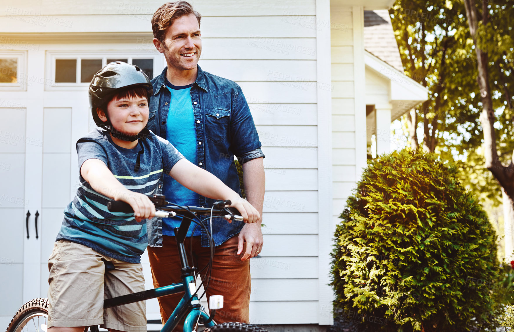 Buy stock photo Support, bicycle and father with boy, smile and learning for growth, bonding together and fitness. House, dad and parent with son, child development and teaching with love, bike and confidence