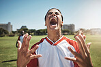 Happy, winning and soccer playing screaming in joy during a match or training on an outdoor field. Success, fitness and excited man athlete at a football game with achievement or goal on sports pitch