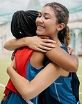 Sport, hug and student girl game match showing support, trust and teamwork on a outdoor field. Student soccer or netball player with a happy smile show diversity and training friendship together