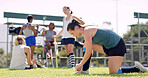 Woman, fitness and tying with shoe for sport, hockey game or outdoor preparation on grass field. Active, female person or player getting ready with tie or sneakers for match, training or practice