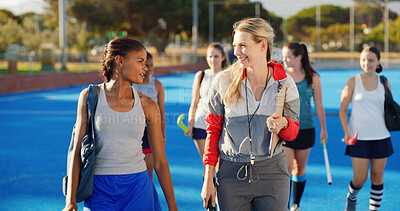 Buy stock photo Finish, hockey and women outdoor with coach talking after training, practice and exercise. Team, happy and people in conversation after playing match, game and tournament on turf for sports hobby