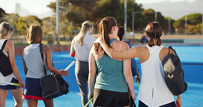 Buy stock photo Walking, field hockey and back of women outdoor to start training, practice and exercise. Team, hug and people in conversation ready for playing match, game and tournament on turf for sports hobby