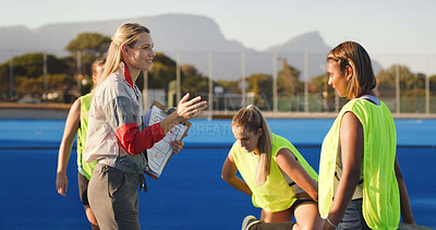 Buy stock photo Women, coach and hockey team with clipboard, game planning and feedback for training at club. People, group and athlete with checklist, discussion or insight for fitness routine at sports ground