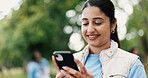 Phone, typing and volunteer with woman in park for charity, community outreach or food drive. App, smile and text message with happy person outdoor for activism, donation or ngo communication