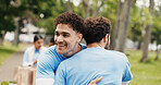Happy man, hug or volunteer with embrace for community service or commitment together in park. Male person, team or NGO with smile, trust or support for global outreach, charity or donation in nature