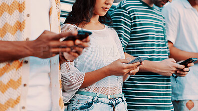 Buy stock photo Hands, phone and text message with people outdoor together for connection or social media browsing. App, contact and typing with group of friends in line for communication, online chat or reading
