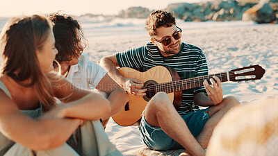 Buy stock photo Beach, friends and play guitar on holiday, relax and bonding together outdoor for summer celebration. Seashore, group and people with acoustic instrument for travel music, song or smile on vacation