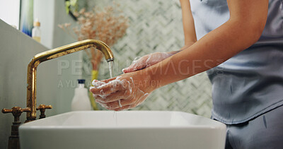 Buy stock photo Water, hygiene and woman washing hands in bathroom for removal of germs, dirt or bacteria. Sink, soap and female person with cleaning skin for health, wellness or virus safety routine in home.