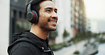 Listening, outdoor and happy man with headphones in city, streaming music or explore town for tourism. Sightseeing audio track, location podcast and person with urban info, tech or travel in New York