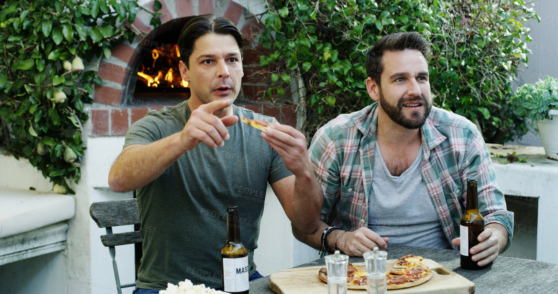 Buy stock photo Pizza, beer and friends watching football outdoor in backyard for sports tournament with suspense. Bonding, anxious and people streaming competition with food and alcohol for soccer match at home.