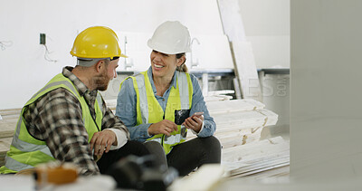 Buy stock photo Conversation, happy and friends on construction site with phone, colleague gossip or app scroll during work rest. Digital, people and contractors with tech, social chat and online search on break.