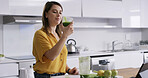 Drink, woman and smile in home for breakfast, healthy diet and green fruit smoothie. Person, blender and technology in kitchen to prepare ingredients, meal prep or nutrition shake for weigh loss