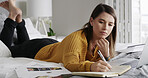 Woman, notebook and writing on bed with remote work from home, food review or report for website. Person, cuisine journalist and freelancer with tech, documents and article planning for blog at house