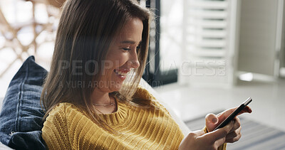 Buy stock photo Happy woman, relax and typing in home with phone, social media post or dating site notification. Female person, smile or scroll on sofa with tech, text message or mobile app for online communication.