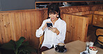 Business woman, phone and scroll in coffee shop for break, social media or notification. Mature freelancer, research and tech with internet for article, website or review in cafe for project proposal