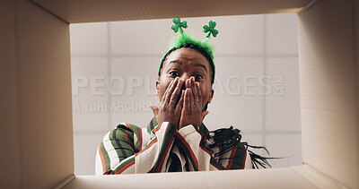 Buy stock photo Surprise, opening and pov of black woman with box for present, gift and package for St Patricks day. Shamrock, below and portrait of person with parcel for shock, wow and excited for celebration