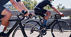 Hands, people and cycling on bike in road for marathon practice, competition workout or fitness. Sport, cyclists and bicycle outdoor for cardio exercise, endurance challenge or pace training for race