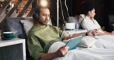 Buy stock photo Headphones, man and tablet with drip therapy in lounge for nutrients, recovery or streaming app. Flare, patient and tech with IV vitamin c for health benefits, mineral infusion or immune system boost