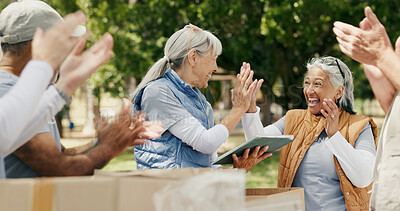Buy stock photo Volunteer, high five and people in park with tablet, teamwork and clap in relief campaign support. Success, mature women outdoor with technology, collaboration and motivation in charity project.