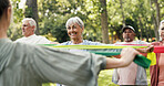 Stretching, resistance band and class with old woman in park for learning, mobility exercise and health club. Muscle warm up and wellness with senior people for low impact workout and instructor