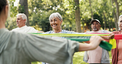 Buy stock photo Stretching, resistance band and class with old woman in park for learning, mobility exercise and health club. Muscle warm up and wellness with senior people for low impact workout and instructor