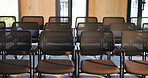 Chairs, seminar and empty room for business event, forum and convention or meeting venue. Furniture, hall and interior of conference center with rows for summit, presentation or seats for workshop