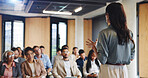Back of woman, audience and speaker with presentation, business conference and seminar event. Workshop, training and feedback summit with coach, sales education and crowd for career development