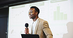 Presentation, speaking or man with tech at podium, company stats or performance data review. Business seminar, laptop or African presenter with mic for info analysis, explain digital charts or graphs
