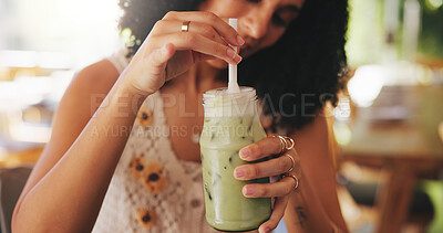 Buy stock photo Hands, matcha or drink with woman in coffee shop with iced beverage for thirst, refreshing or hydration with stir. Green smoothie, milkshake and person mixing cold liquid in glass with straw at cafe