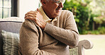 Hands, sofa and shoulder pain in home, injury and senior man in lounge with joint inflammation. Elderly person, frustrated and muscle fatigue for rotator cuff strain, tendinitis or stress at house