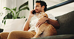 Dog, hands and hug for care on couch, relax and man with phone call, happy or contact in home. Pet animal, loyalty and embrace for comfort in lounge, smartphone and low angle on sofa at apartment