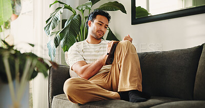 Buy stock photo Man, journal and writing on sofa in house, daily reflection or idea notes to relax for creativity. Person, notebook for planning or sketching with agenda in diary, to do list or goal setting in home